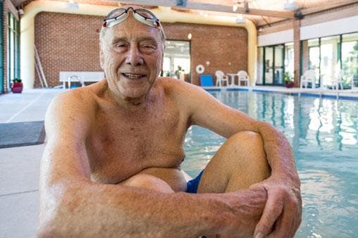 Man sitting next to pool