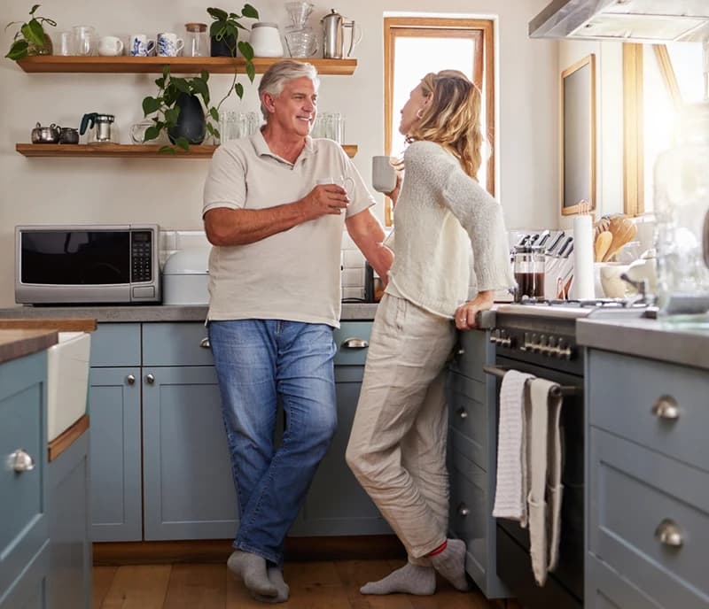Man and woman talking in kitchen