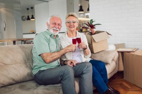 planning-your-next-step-preparing-move-senior-living_a-couple-celebrating-a-move-to-the-community