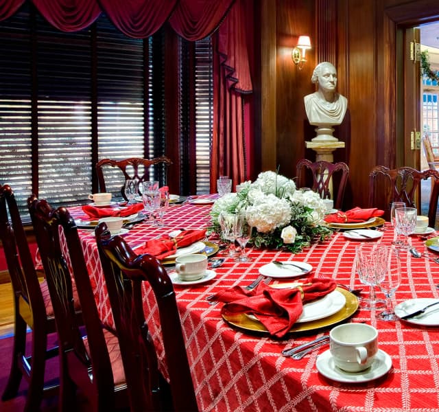 Elegant dining room with statue in background