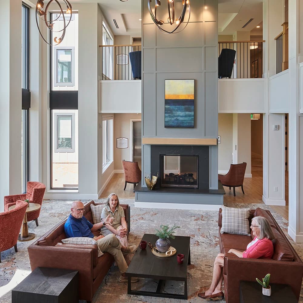 Open modern public area with residents on couches