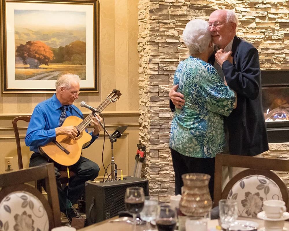 Man and woman dancing to live music